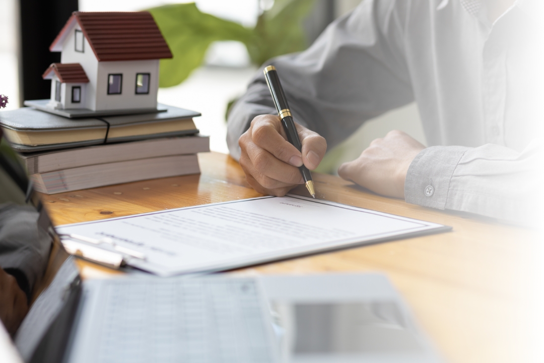 Close up of person filling out a form on a clipboard and I assume is smiling for some reason