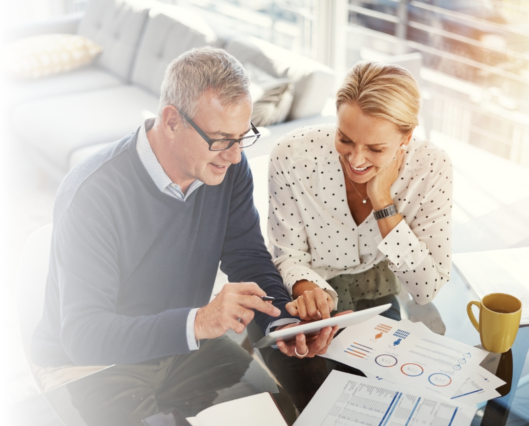 Couple going over paperwork and smiling for some reason